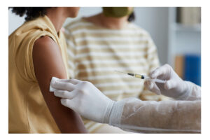 Doctor giving vaccine to woman